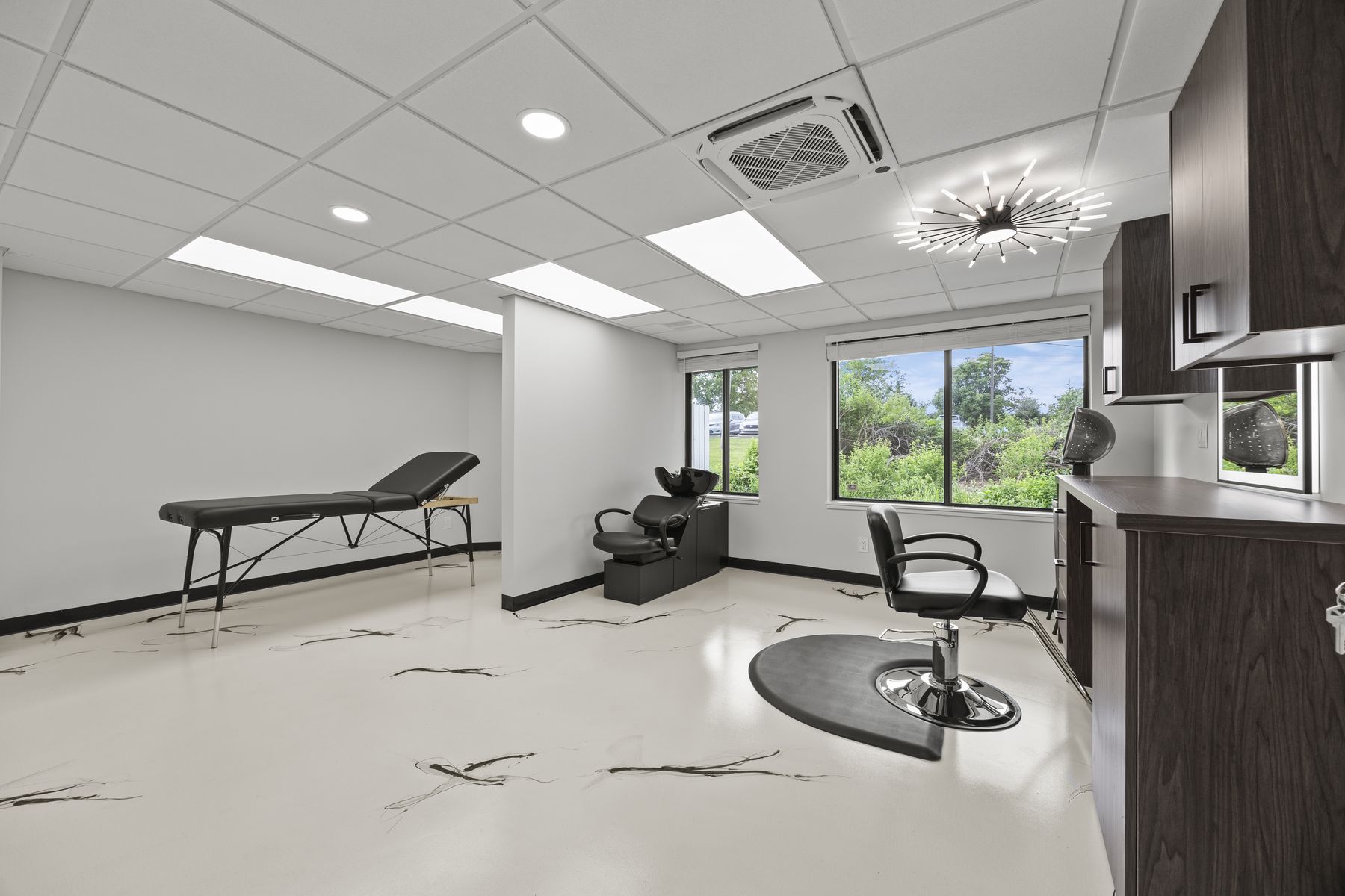 Flex room with a styling station, shampoo bowl and treatment bed