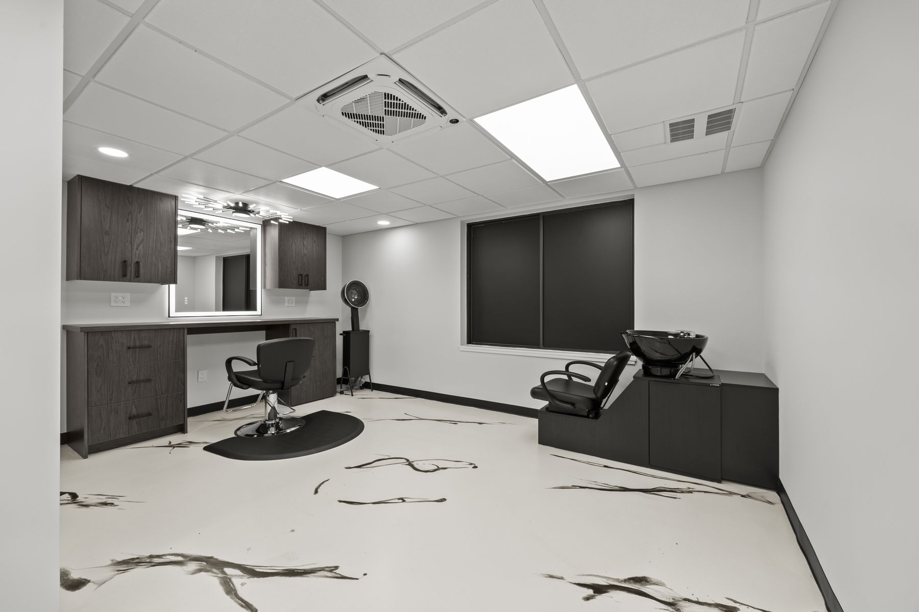 Hair suite with a shampoo station and window shades